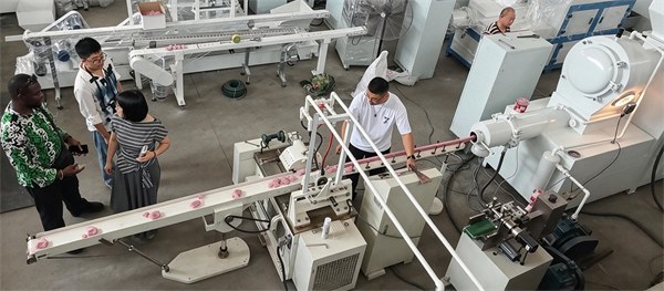 Overseas customer visiting complete automatic soap production line, testing pink soap bar making machine