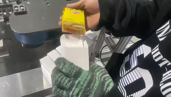 Inspecting packaged laundry soap inside carton after cartoning test